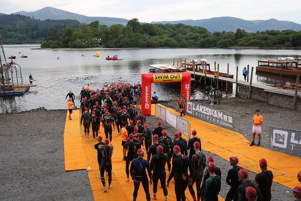 Athletes entering Derwentwater at the swim start