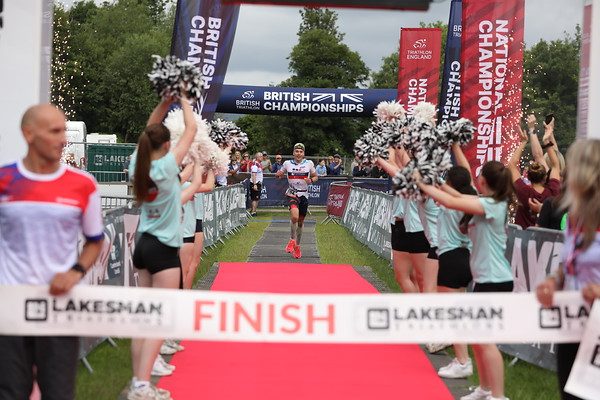 Athlete crossing the Lakesman finish line