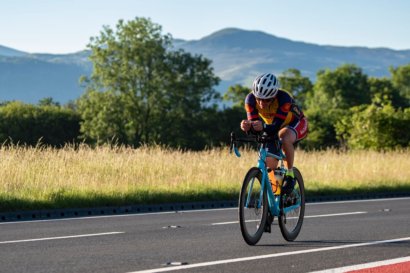 Cyclist on the Lakesman bike course with the Lakeland fells behind